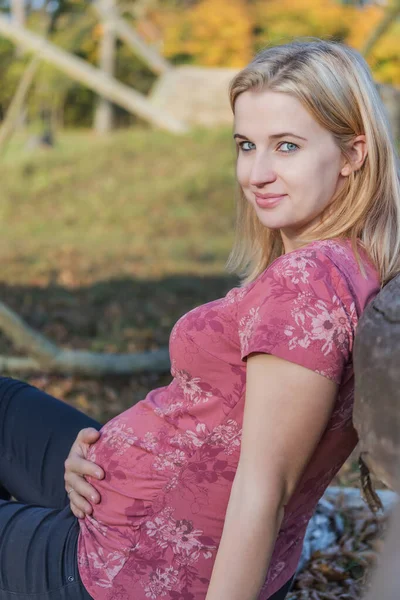 Jeune femme enceinte tient son ventre de grossesse — Photo