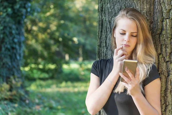 Meisje leest bericht op smartphone. — Stockfoto