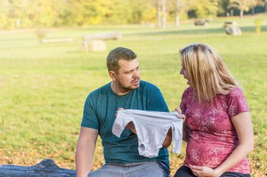 Future parents in quarrel about clothes for baby
