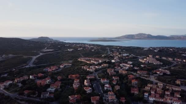 Aerial of a pretty village in Sardinia, Italy. Sunrise on the coast, mountains — Stock Video