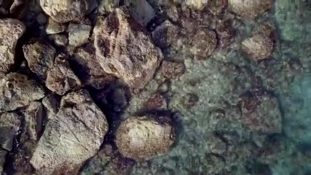 Aerial beautiful view. Waves are washing on stones and pebbles on the shore. Calpe Spain — Stockvideo