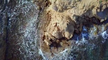 Aerial beautiful view. Waves are washing on stones and pebbles on the shore. Calpe Spain