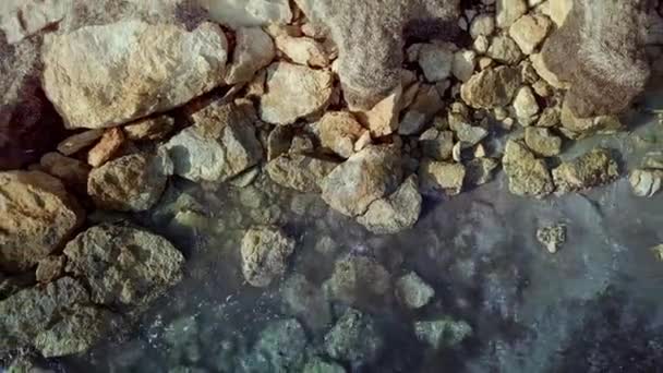 Aerial beautiful view. Waves are washing on stones and pebbles on the shore. Calpe Spain — Stock Video