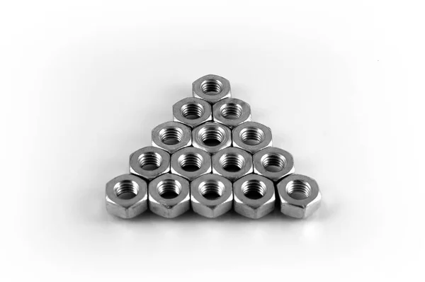 Metal Nuts Stacked Shape Equilateral Triangle White Background — Stock Photo, Image