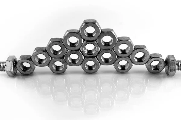 Metal Nuts Stacked Top Each Other Shape Pyramid Reflection White — Stock Photo, Image