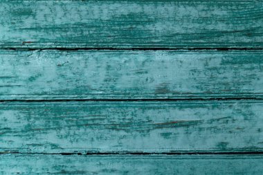 Doku eski bir ahşap yüzey, bazen güneşte yanmış turkuaz boya ile boyanmış ve kırık.