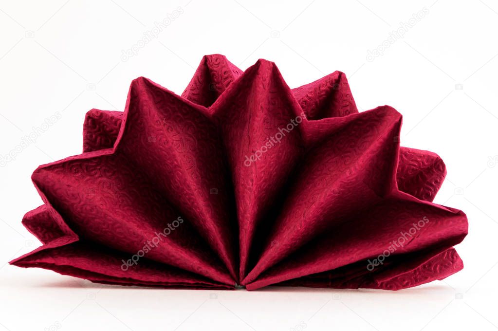 Bard napkin folded in the form of a flower on a white background.
