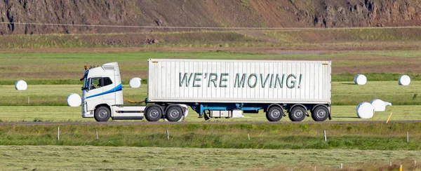 Truck driving through a rural area - We're moving — Stock Photo, Image