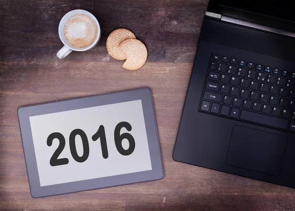 Tablet touch computer gadget on wooden table - 2016 — Stock Photo, Image