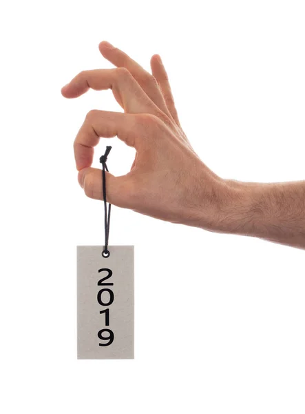 Mão segurando uma etiqueta - Ano Novo - 2019 — Fotografia de Stock