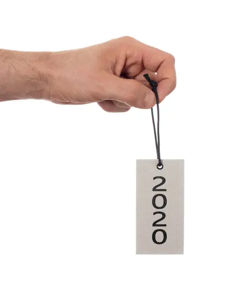 Hand holding a tag - New year - 2020 — Stock Photo, Image