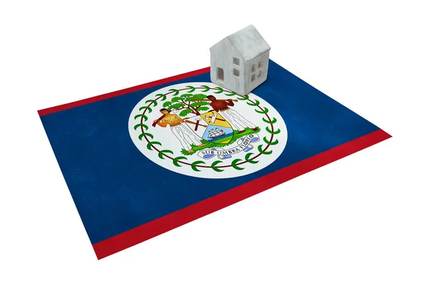 Small house on a flag - Belize — Stock Photo, Image