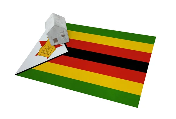 Small house on a flag - Zimbabwe — Stock Photo, Image