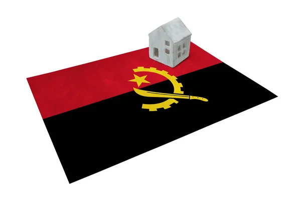 Маленький дом на флаге - Ангола — стоковое фото