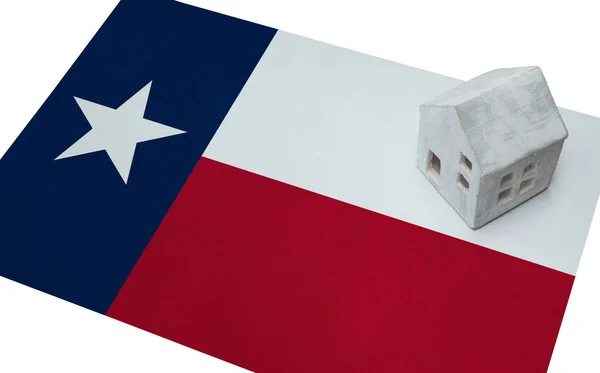 Small house on a flag - Texas — Stock Photo, Image