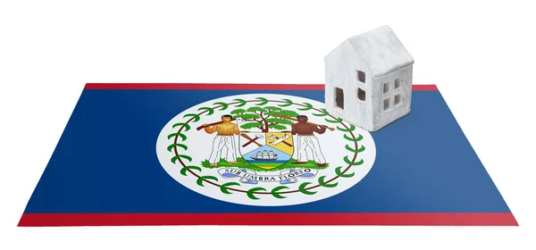 Small house on a flag - Belize — Stock Photo, Image