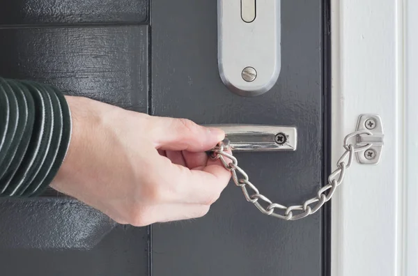 Door chain on a grey door — Stock Photo, Image