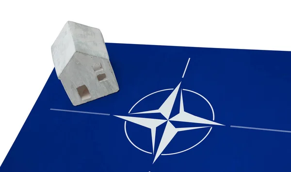 Small house on a flag - NATO — Stock Photo, Image
