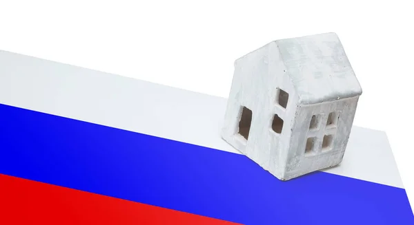 Small house on a flag - Russia — Stock Photo, Image