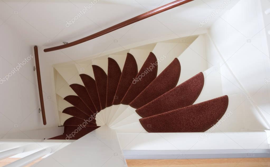 White wooden stairs with red mats