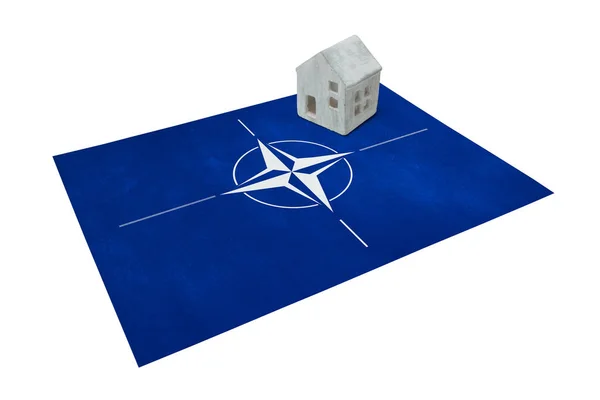 Small house on a flag - NATO — Stock Photo, Image