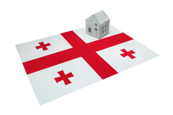 Small house on a flag - Georgia — Stock Photo, Image