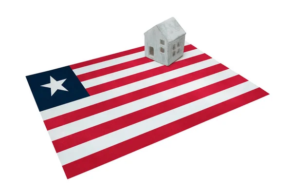 Small house on a flag - Liberia — Stock Photo, Image