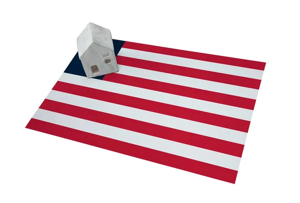 Small house on a flag - Liberia — Stock Photo, Image