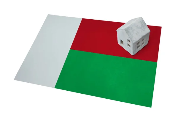 Small house on a flag - Madagascar — Stock Photo, Image