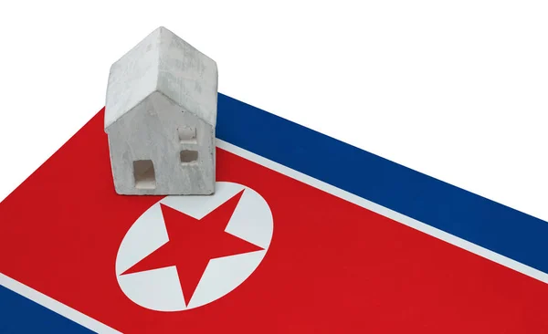 Small house on a flag - North Korea — Stock Photo, Image