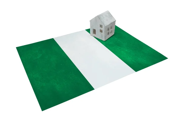 Small house on a flag - Nigeria — Stock Photo, Image