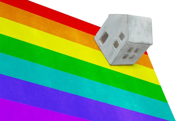 Small house on a flag - Rainbow flag — Stock Photo, Image