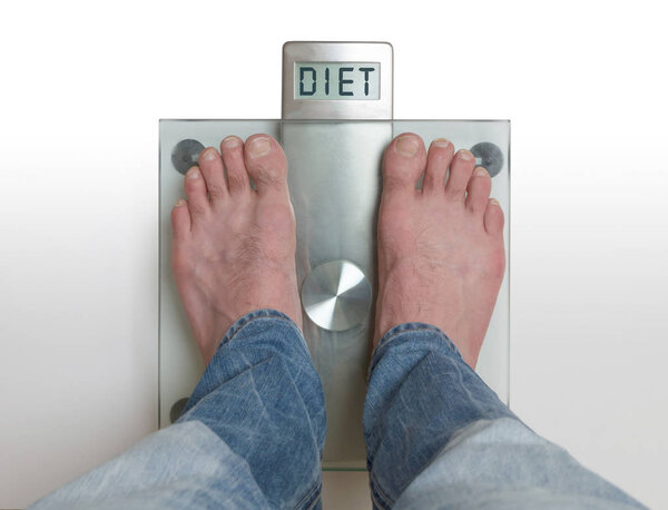 Man's feet on weight scale - Diet