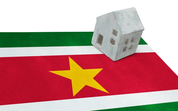 Small house on a flag - Suriname — Stock Photo, Image