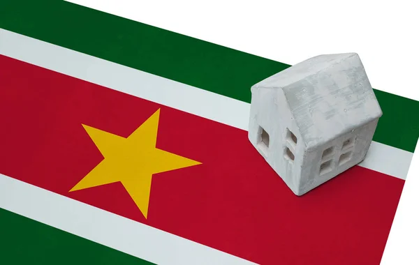 Small house on a flag - Suriname — Stock Photo, Image