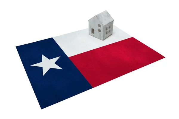 Small house on a flag - Texas — Stock Photo, Image