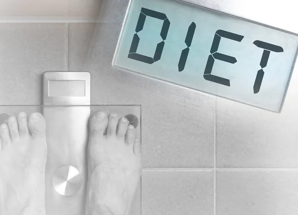Man\'s feet on weight scale - Diet