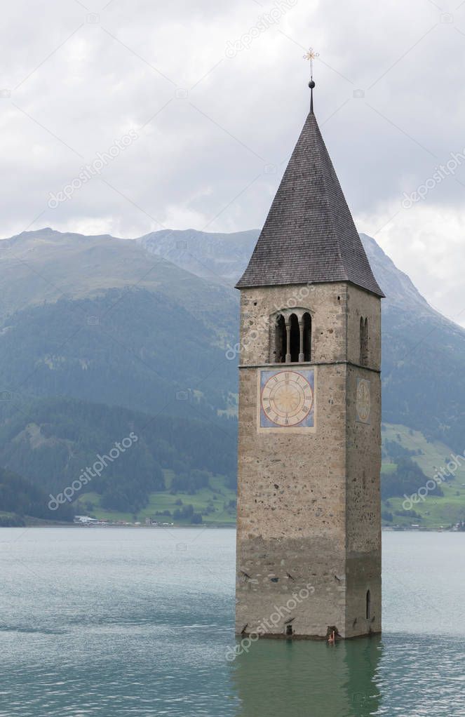 Submerged tower of reschensee church deep in Resias Lake in Tren