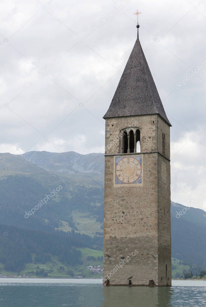Submerged tower of reschensee church deep in Resias Lake in Tren