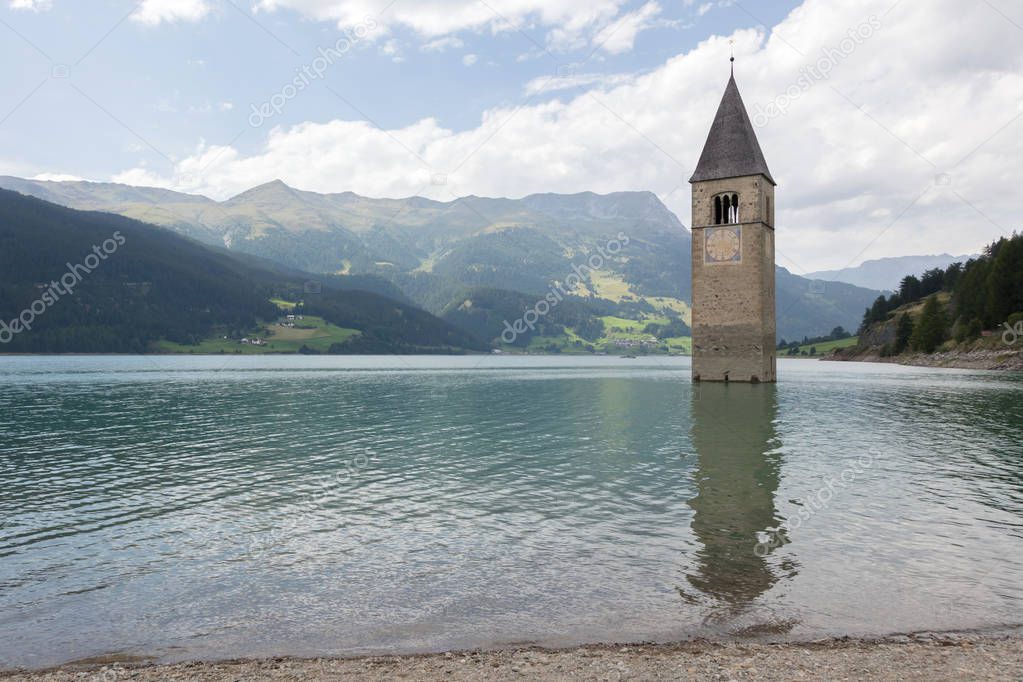 Submerged tower of reschensee church deep in Resias Lake in Tren