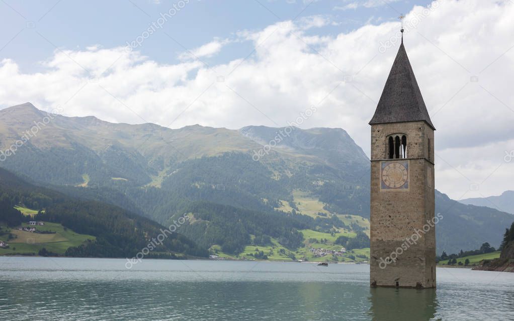 Submerged tower of reschensee church deep in Resias Lake in Tren