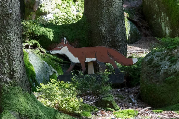 Education in the forest - wooden fox waiting to be spotted by ch — Stock Photo, Image