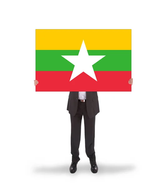 Empresario sosteniendo una tarjeta grande, bandera de Myanmar —  Fotos de Stock