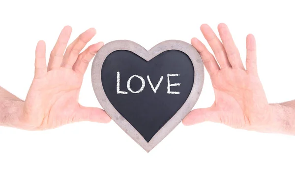 Adult holding heart shaped chalkboard — Stock Photo, Image