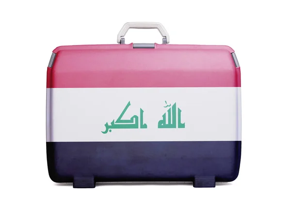 Used plastic suitcase with stains and scratches, printed with flag, Iraq