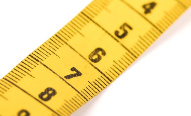 Close-up of a yellow measuring tape isolated on white - 7