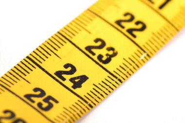 Close-up of a yellow measuring tape isolated on white - 24
