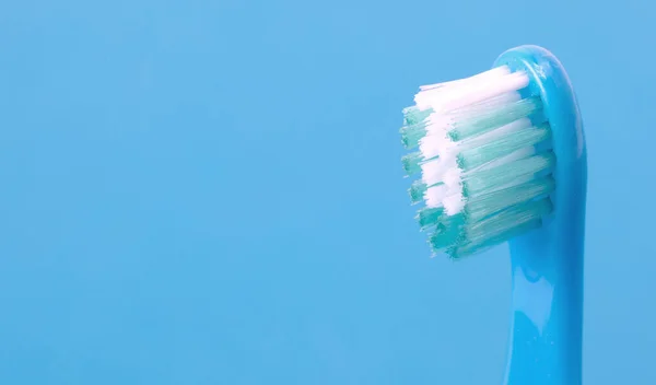Dental care toothbrush isolated on blue background