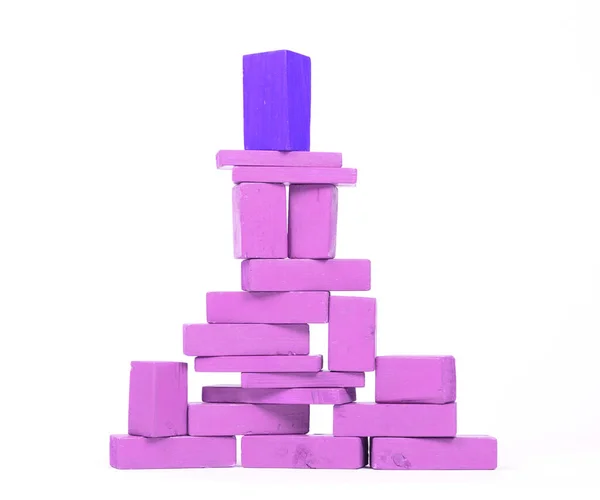 Vintage purple building blocks isolated on white background, one standing out