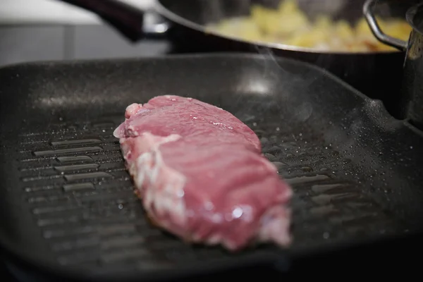 Raw beef steak in a pan — ストック写真